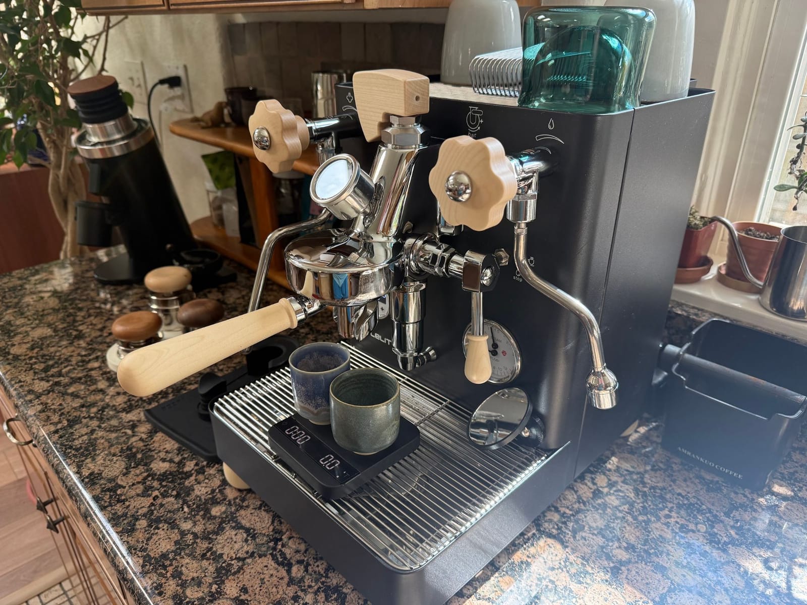 The espresso machine with maple handles, two cups on a scale